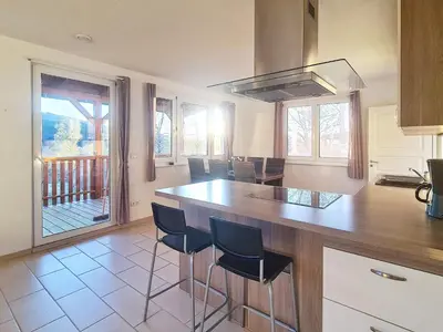 a kitchen with a island with stools in it at 5 person holiday home in LONEVÅG-By Traum in Lonevåg