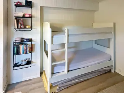 a small bedroom with bunk beds in a room at 6 person holiday home in AVERØY-By Traum in Stein