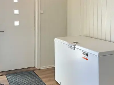 a white refrigerator in a room next to a door at 6 person holiday home in AVERØY-By Traum in Stein
