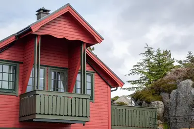 a red house with a balcony at Fanøy Island Lodge in Fanoyna