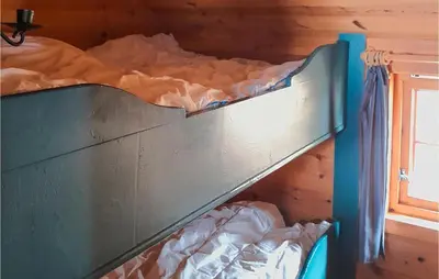 a bunk bed in a room with a window at 4 Bedroom Nice Home In Etne in Etnesjøen