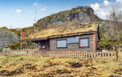 a house with a grass roof on top of a hill at 4 Bedroom Nice Home In Etne in Etnesjøen