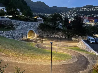 a tunnel in a hill with cars parked in it at Moderne og sentral leilighet med koselig og privat uteplass! in Hornnes