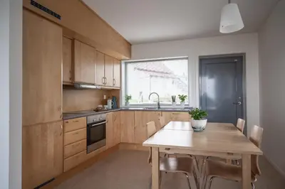 a kitchen with a wooden table and a window at Runde Miljøsenter & Opplev Runde in Runde