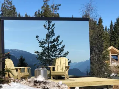 a large screen with two chairs and a table at Vidsyn Midjås in Vistad