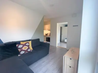 a living room with a blue couch and a table at Cozy apartment in Hafjell - Øyer centre in Hafjell