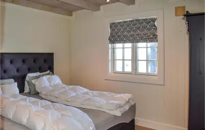 a bedroom with a bed and a window at Gorgeous Home In Rauland in Rauland