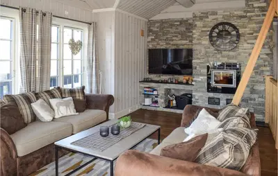 a living room with two couches and a tv at Gorgeous Home In Rauland in Rauland