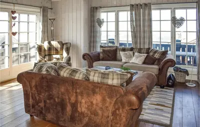 a living room with a couch and chairs and windows at Gorgeous Home In Rauland in Rauland