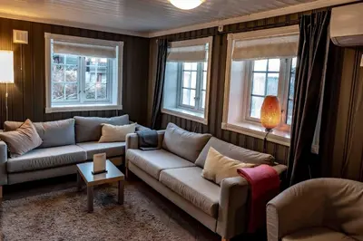 a living room with two couches and two windows at Storsten 730 in Trysil