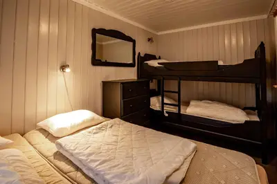 a bedroom with two bunk beds and a mirror at Storsten 730 in Trysil
