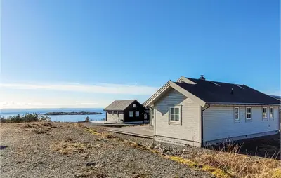a couple of buildings sitting on top of a hill at Gorgeous Home In Sveio With Wifi in Sveio