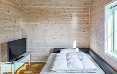 a bedroom with a bed and a flat screen tv at Gorgeous Home In Sveio With Wifi in Sveio