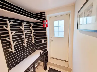 a hallway with a black and white striped wall at Ibsens apartaments in Bergen