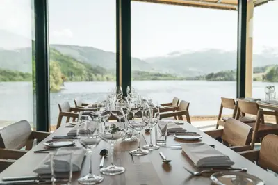 a dining room with a table with wine glasses at Elva Hotel in Vossevangen