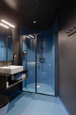 a bathroom with a glass shower and a sink at Elva Hotel in Vossevangen