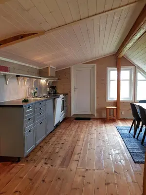 a kitchen with wooden floors and a wooden ceiling at Leilighet Vikaparken Hardangerfjord in Hatlestrand