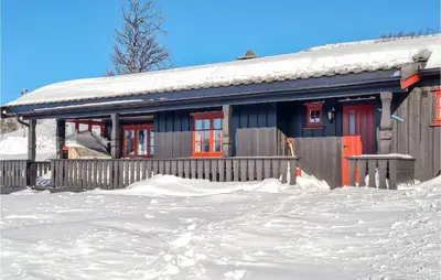 a house with red doors in the snow at 3 Bedroom Lovely Home In Beitostølen in Beitostøl