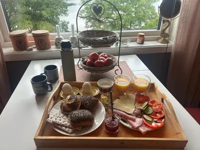 a tray of breakfast food on a table with a window at Line på Hauane1 in Volda