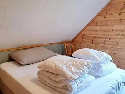 a bed with two pillows and a blanket on it at 6 person holiday home in Gudvangen-By Traum in Gudvangen