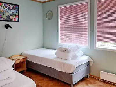 a bedroom with two twin beds and two windows at 6 person holiday home in Gudvangen-By Traum in Gudvangen