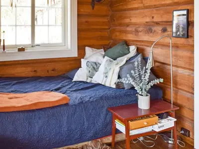 a bedroom with a blue bed and a table at 6 person holiday home in HURDAL-By Traum in Hurdal