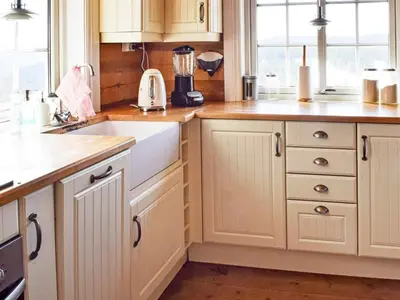 a kitchen with white cabinets and a white sink at 6 person holiday home in HURDAL-By Traum in Hurdal