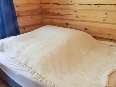 a white bed in a room with a wooden wall at 6 person holiday home in HURDAL-By Traum in Hurdal