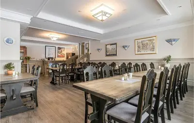 a restaurant with tables and chairs in a room at Lovely Apartment In Tisleidalen in Golsfjellet