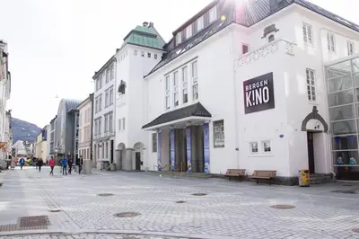 a street with a white building with a sign on it at Dinbnb Homes I 4-Bedroom Historical House in Romantic Surroundings in Bergen