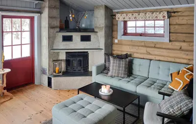 a living room with a couch and a fireplace at 4 Bedroom Cozy Home In Reinli in Reinli