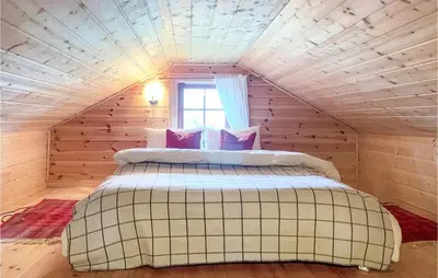 a bedroom with a large bed in a attic at 4 Bedroom Cozy Home In Reinli in Reinli