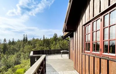 a wooden deck on the side of a building at 4 Bedroom Cozy Home In Reinli in Reinli