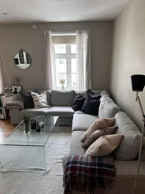 a living room with a couch and a glass table at Modern Apartment in the center of Bergen in Bergen