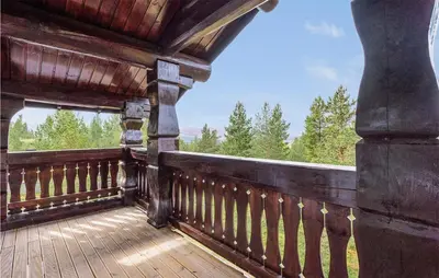 a wooden balcony with a view of trees at Beautiful Home In Dalholen With Sauna in Furuhovde