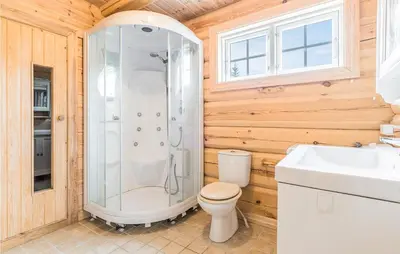 a bathroom with a shower and a toilet and a sink at Beautiful Home In Dalholen With Sauna in Furuhovde