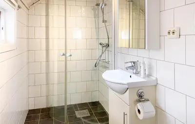 a white bathroom with a sink and a shower at Stunning Home In Ålesund With Kitchen in Ålesund