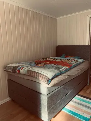 a bed sitting in a corner of a room at Solvik #apartment #Loen in Loen