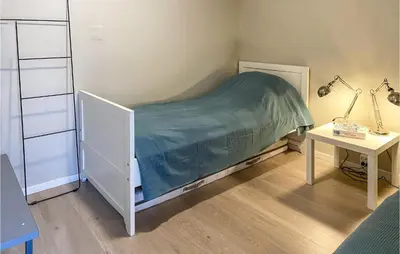 a small bedroom with a bed and a table at Pet Friendly Apartment In Tresfjord in Tresfjord