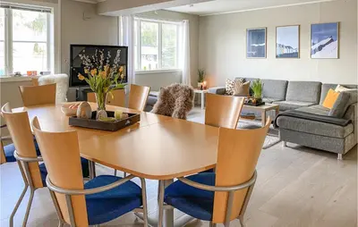 a living room with a wooden table and chairs at Pet Friendly Apartment In Tresfjord in Tresfjord