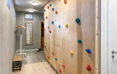a climbing wall in a room with a rock wall at Pet Friendly Apartment In Tresfjord in Tresfjord