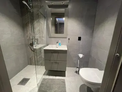 a bathroom with a shower and a sink and a toilet at Riddertunet apartment 104 - in the center of Beitostølen in Beitostøl
