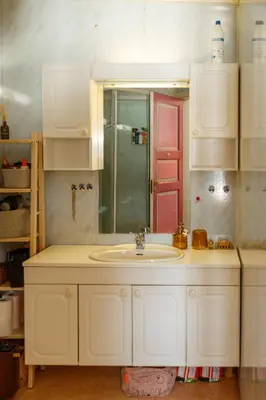 a white bathroom with a sink and a shower at Vinjestogo- mesmerizing mountain view, sauna with a view and eco living in an old school house in Løken
