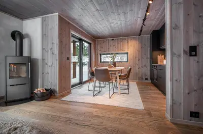 a kitchen and dining room with a table and chairs at Exclusive Suite in the Sunnmøre Alps, Near Geiranger & Hjørundfjord in Stranda