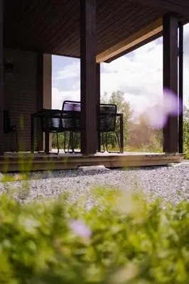 three chairs sitting on the porch of a house at Exclusive Suite in the Sunnmøre Alps, Near Geiranger & Hjørundfjord in Stranda