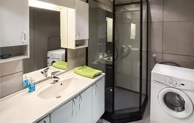 a bathroom with a sink and a washing machine at Beautiful Apartment In Noresund in Noresund