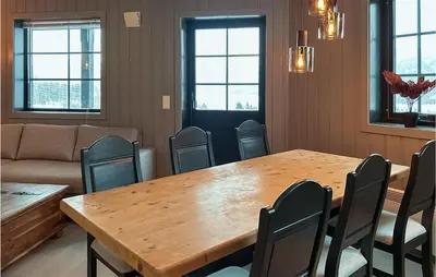 a conference room with a wooden table and chairs at Beautiful Apartment In Noresund in Noresund