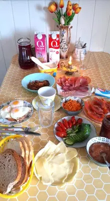 a table with many plates of food on it at Gjesterom til leie i et privat hus in Brumunddalen
