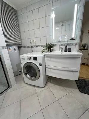a kitchen with a washing machine and a sink at Apartment in Åsane in Bergen