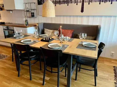 a dining room table with chairs and wine glasses at Skarsnuten Panorama 46 in Hemsedal